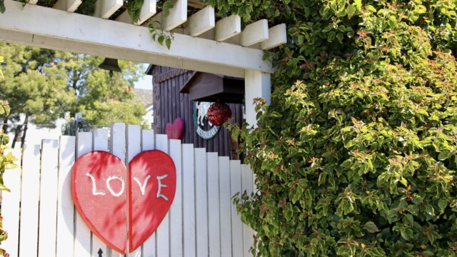Behind the "Love" gate lies the San Benito House wedding venue, where couples can celebrate their love between flowers and foliage. Photo credit: Julia Goldman