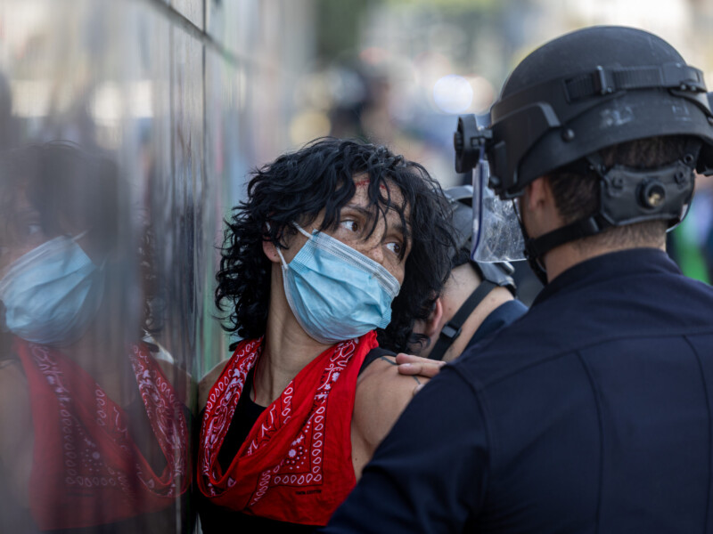 A protester pleads with the police after being detained during an anti-ICE protest on Temple and Alameda Streets on June 8. Ethan Cohen | Long Beach Current