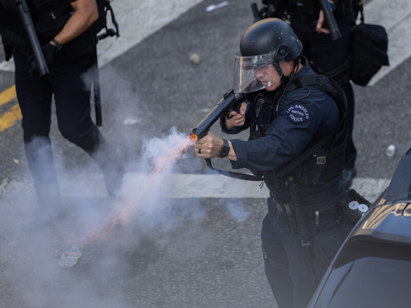 A Los Angeles Metro Police officer fires rubber bullets at protesters in front of City Hall on June 8. Ethan Cohen | Long Beach Current